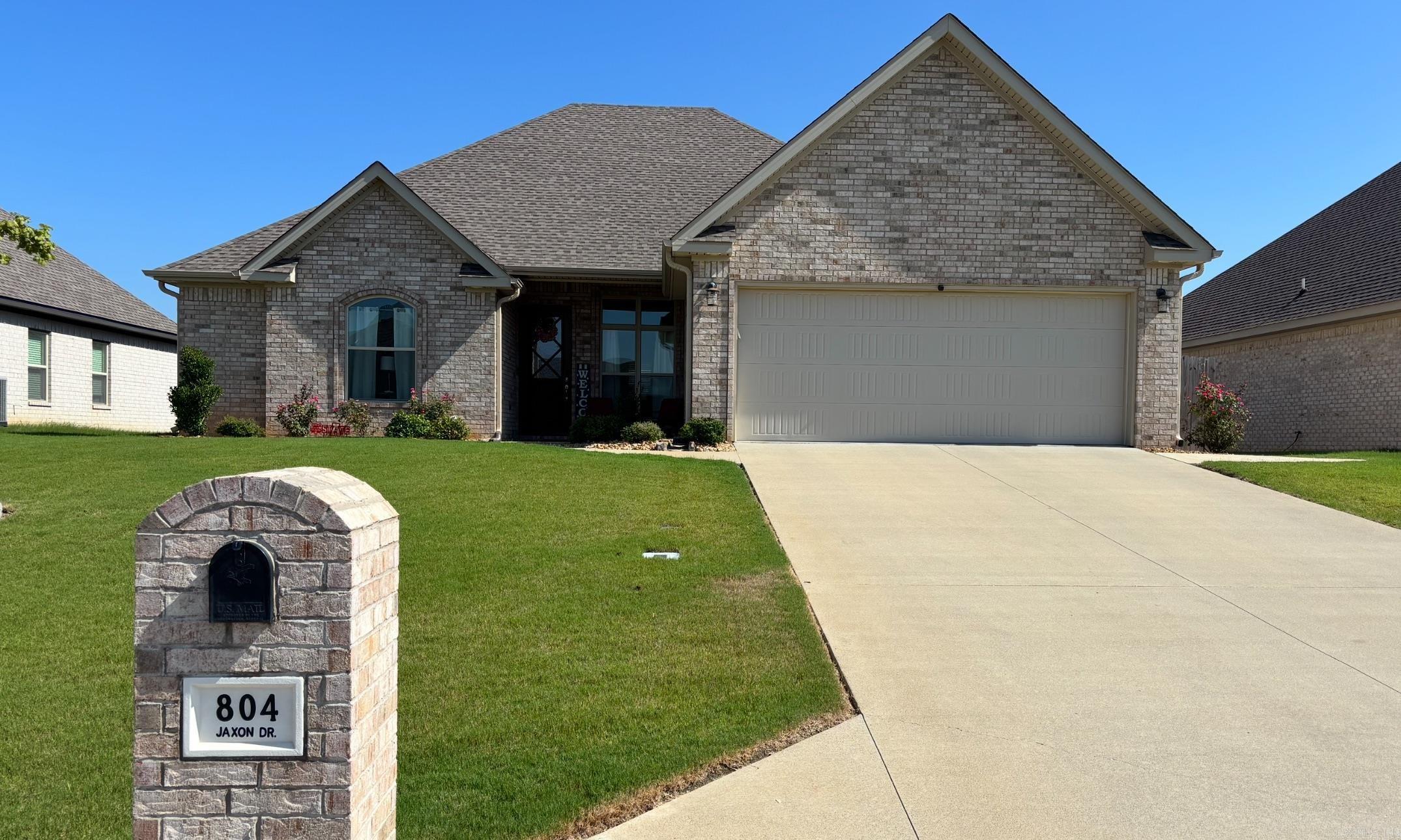 Wonderfully designed 4 bedroom/2 bath home built in 2021, like new and move-in ready. Gorgeous gas log brick fireplace featured in the open living area. Kitchen with dining area, large pantry and breakfast bar opens to the living area. Formal area for more dining, or additional family room. Beautiful crown molding throughout the home with extra detail around windows and doorways. The spacious primary bedroom opens to the large bath complete with walk-in tiled shower, soaker tub and large walk-in closet with built in shelving. The additional three bedrooms are all generous sized with two of the three also featuring walk-in closets. The second bath features large vanity with double sinks. The home includes a large laundry room and area when entering the home from the two car garage. Stepping outside this beautiful home is a wonderful enclosed patio, additional outside patio, added custom sidewalks around the home. A custom built 10'x16'shop/storage building was constructed in 2024 and is located inside the privacy fenced back lawn complete with work bench and electricity. The entire lawn includes a Rain Bird inground sprinkler system.