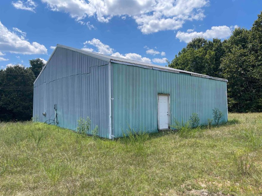 18+ Unrestricted and surveyed acres with 1,600 sq ft Shop in North Central Arkansas – Prime Location on US Highway 62/412  This 18+-acre property in Fulton County, Arkansas, offers unlimited potential with no restrictions. Featuring a 1,600 sq ft shop with concrete floors, electricity, and a private well, it’s ready for a variety of uses—business, storage, or even conversion to living space. The land is approximately half cleared and half wooded, perfect for livestock, recreation, or building your dream home. Located on US Highway 62/412, it provides excellent visibility and access, just 20 minutes to Mountain Home and 10 minutes to Norfork Lake. The property includes three driveways for easy entry and exit, rural water, and NEXT high-speed fiber internet for remote work or streaming. Recently surveyed for your peace of mind. This is an exceptional opportunity for those seeking a homestead, mini-farm, RV park, or commercial location in a prime area of North Central Arkansas. Contact us today to see everything this versatile property has to offer.