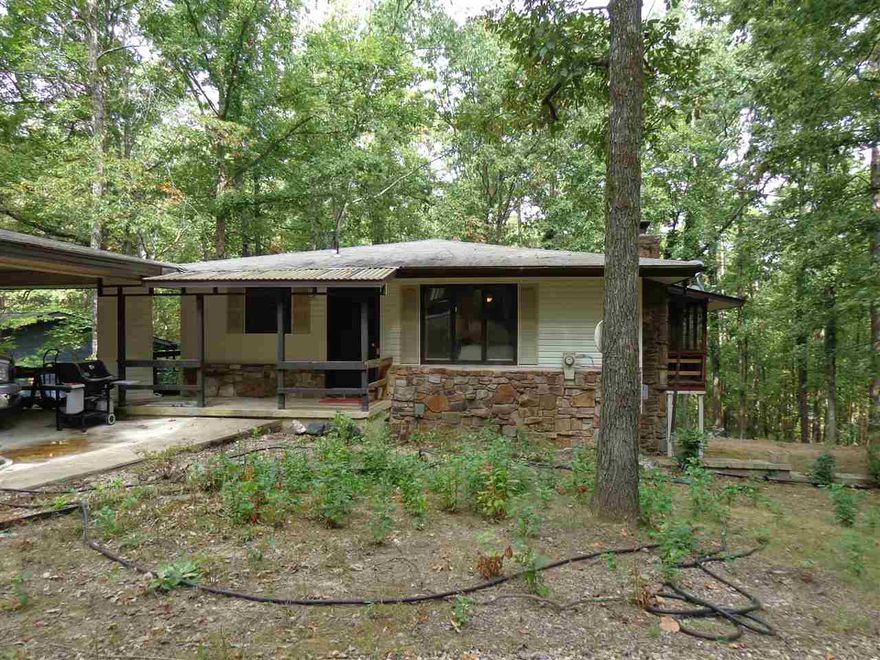 Lots of character and square footage in this cozy home. Many nice surprises inside including new wood, laminate, tile and carpet. Upstairs has massive stone fireplace, screened porch, open kitchen with island, dining room, bedroom & laundry. Lower level has newly remodeled 2nd living area with fireplace, bedrooms & bath. The heated/cooled workshop will please the handyman. Located on a peaceful wooded lot in the largest gated community in the US with 11 lakes and 9 golf courses and many other amenities.