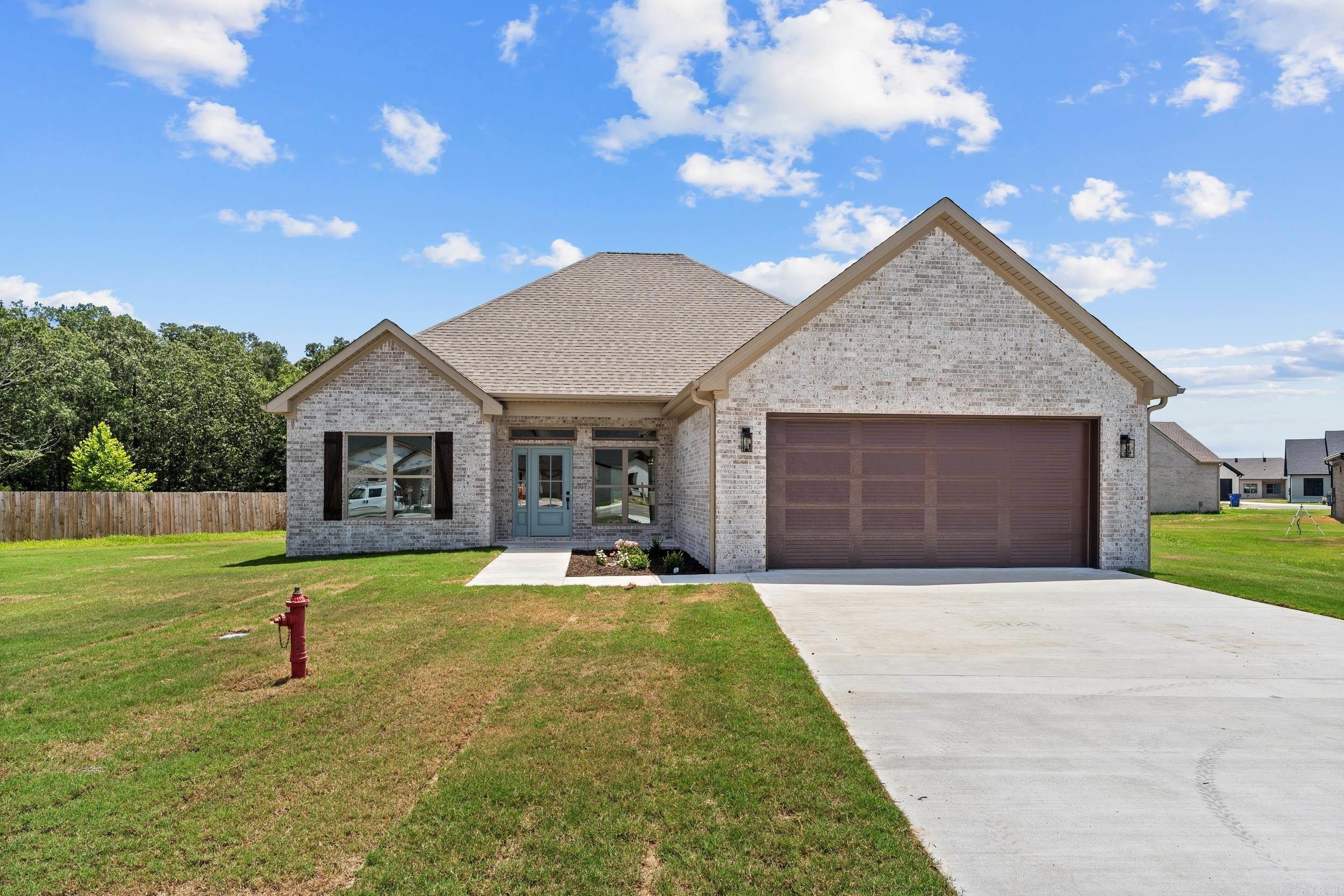 Quality New Construction by Bison Homes in Greenbrier! This beautifully crafted all-brick home showcases curb appeal with its light brick exterior, architectural rooflines, and spacious covered front entry. Inside, you'll find a thoughtfully designed split floor plan featuring durable Coretec luxury vinyl plank flooring, Fantasy Brown granite countertops, and a stylish electric fireplace. Premium Delta plumbing fixtures add a refined touch throughout. The open-concept living area is filled with natural light, and the spacious kitchen/breakfast room is perfect for gatherings. The primary suite offers a luxurious retreat with a custom tile shower. All bedrooms are generously sized, providing flexibility for any lifestyle. This home combines function, beauty, and craftsmanship in a desirable neighborhood. Check it out today!