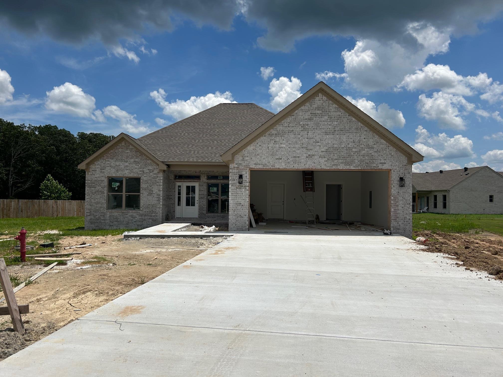 Quality New Construction by Bison Homes in Greenbrier! This beautifully crafted all-brick home showcases curb appeal with its light brick exterior, architectural rooflines, and spacious covered front entry. Inside, you'll find a thoughtfully designed split floor plan featuring durable Coretec luxury vinyl plank flooring, Fantasy Brown granite countertops, and a stylish electric fireplace. Premium Delta plumbing fixtures add a refined touch throughout. The open-concept living area is filled with natural light, and the spacious kitchen/breakfast room is perfect for gatherings. The primary suite offers a luxurious retreat with a custom tile shower. All bedrooms are generously sized, providing flexibility for any lifestyle. This home combines function, beauty, and craftsmanship in a desirable neighborhood. Check it out today!