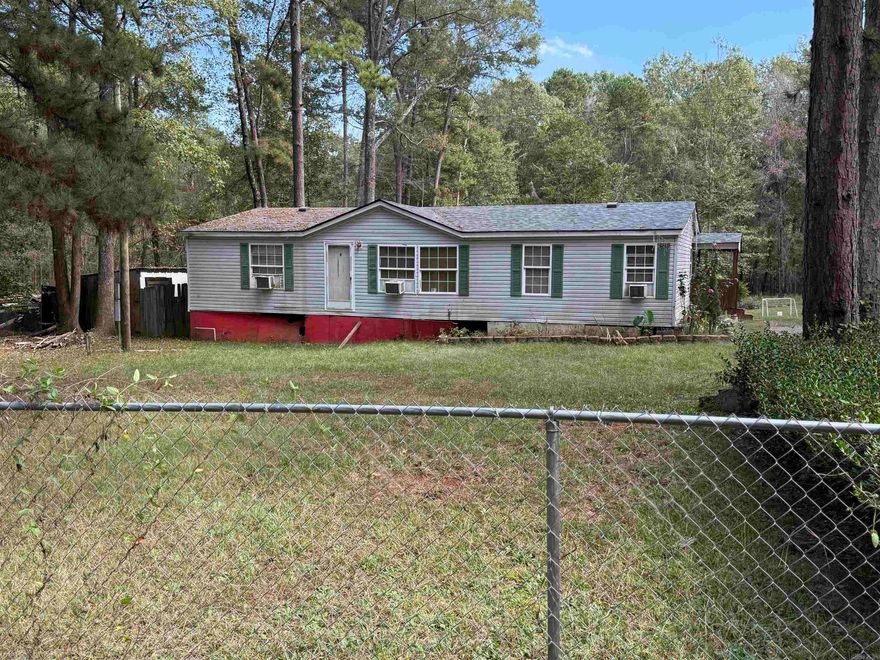 Endless possibilities await with this doublewide mobile home sitting on 2.75 beautiful acres! Whether you’re an investor searching for your next project or a homeowner ready to create your own country retreat, this property offers incredible potential. The home features a great floor plan with plenty of room to reimagine and update to your liking. Surrounded by mature trees to includes pecan trees and a peach tree out front, the setting provides privacy, peace, and plenty of space for outdoor living. There’s room to add a garden, workshop, or even expand in the future.With a little vision and effort, this fixer-upper could be transformed into a comfortable full-time residence or a profitable investment. The property combines the tranquility of country living with the freedom that comes from owning acreage...all while being close to town. Come see the possibilities and bring your ideas to life on this 2.75-acre country property! Being sold as-is, Sellers are motivated.* Agents please see remarks