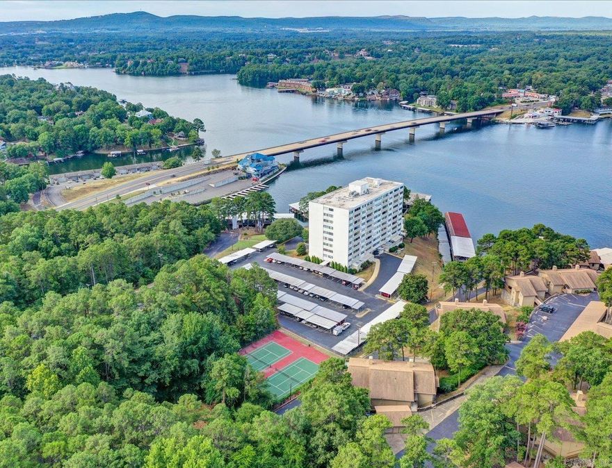 740 Weston, Unit 201 | Fully Renovated Condo – Lake Hamilton Views  Welcome to Unit 201 at 740 Weston, a beautifully updated corner condo in one of Hot Springs’ most desirable gated communities. Enjoy panoramic views of Lake Hamilton from multiple vantage points, plus access to an exceptional array of amenities.  Key Features:  • Corner unit flooded with natural light and expansive lake views  • Fully furnished, move-in ready — all furnishings convey (personal items do not convey)  • Gorgeous, modern upgrades throughout — new finishes, lighting, flooring, cabinetry, and more  • Use of fantastic community amenities: swimming pool, workout room, picnic areas, and secure gated entry for peace of mind  • Spacious outdoor common areas and beautifully landscaped grounds  • Community family room / gathering space for entertaining  • Lake access via shared waterfront and scenic views  • Ideally located with proximity to dining, shopping, entertainment, and lake recreation  Unit 201 offers low-maintenance living in a premier lakefront setting. Whether you’re seeking a full-time residence, vacation retreat, or income-producing condo, this property truly delivers. STR friendly complex