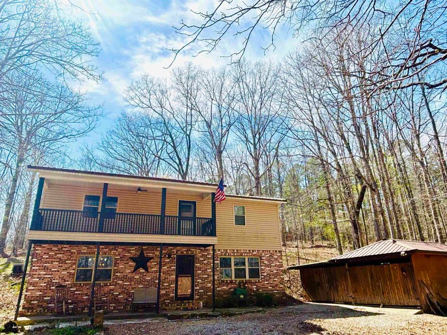 Rare find! This beautiful two-story home offers over 2000 sq ft sitting on over 3 acres, fronts paved Roasting Ear Road in Fifty-Six, and joins the Ozark National Forest on 2 sides!!! That's right, the backyard of this home, to enjoy hunting, hiking, or nature watching, expands to the boundaries of the Ozark National Forest with an abundance of deer, small game, and birds!!! Step onto the covered porch of the walkout basement into the front door to the living room/den with a wood burning stove and bookshelves, a half bath with space to convert to a full, pantry/closet under the stairs, and spacious updated kitchen/dining combo with quality cabinetry. Upstairs, the primary has a walk-in closet and room for a sitting or office area. A laundry room, 2 other bedrooms, and hall to a covered upper front deck. Updated full bath. The backdoor leads out to a private back deck with woodland/nature views. Detached 2 car garage. Shed. Call today!