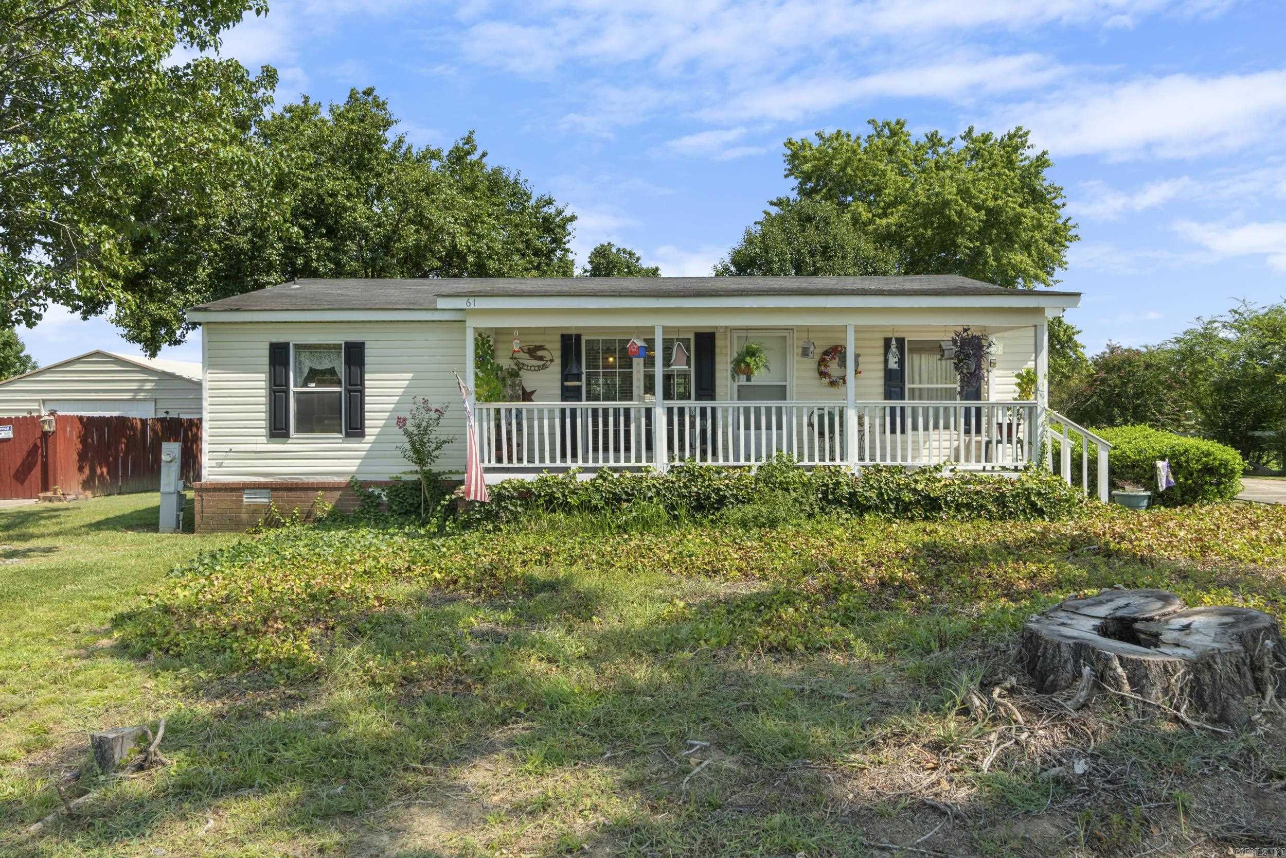 Well maintained home on nearly half an acre located just outside of Conway city limits! This spacious double wide mobile home offers the desirable open, split floorplan, 3 bedrooms, 2 bathrooms, and 1,240 square feet of living space. The spacious primary ensuite includes a walk in closet, soaking tub and separate shower. Enjoy relaxing on the covered front porch or on the back deck that overlooks a huge backyard. Owners have made these updates over the years:Ā Roof, luxury vinyl plank (LVP) flooring in living room, replaced carpet in primary bedroom, kitchen backsplash, replaced front two windows with easy to clean windows, lighting, and ceiling fan. Kitchen refrigerator & storage building included! Schedule a tour today! Agents see remarks.
