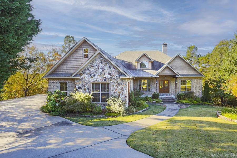 RARE WOODED PRIVACY & SCENIC VIEWS RIGHT IN THE MIDDLE OF WEST LITTLE ROCK!! This incredible custom home in Woodlands Edge is surrounded by green space on three sides offering seclusion rarely found. Featuring a truly stunning greatroom & kitchen with a soaring vaulted ceiling, massive wooden beams and stone fireplace, it is reminiscent of exclusive mountain retreats. Other amenities include plantation shutters throughout, stone countertops, alder cabinets, top quality appliances, custom closets, and en suite baths. The main level features a luxurious primary suite & a handsome office with built-ins plus a formal dining room, 3 bedrooms, & 2 baths. The lower level offers a living space/in-law quarters with mini-kitchen, media room, and two additional bedrooms. Additionally, there is a very large game room, which can function for any number of other uses including man-cave, workshop, or climate controlled storage. Not included in the square footage is an unfinished storage room. This is a wonderfully unique opportunity for you to own a very special home with room for all! ***SEE AGENT REMARKS***