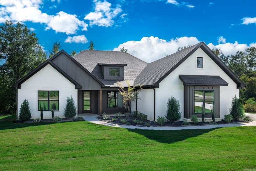 This stunning new construction home in the beautiful North Ridge Estate, just outside of Arkadelphia, offers the perfect blend of style and function. Featuring four spacious bedrooms and three bathrooms, this home boasts an open-concept living, kitchen, and dining area designed for entertaining and everyday living. The kitchen offers tons of counter space, a massive walk-in pantry, and a layout that makes meal prep effortless. The luxurious primary suite includes a large soaking tub, oversized shower, and separate his-and-hers walk-in closets. The guest bedrooms are connected by a convenient Jack-and-Jill bath, providing both privacy and practicality. Outside, you’ll find extra landscaping that enhances curb appeal and a back porch with a cozy fireplace, ideal for relaxing evenings. Sitting on over an acre, this property provides plenty of space and a peaceful setting to call home.