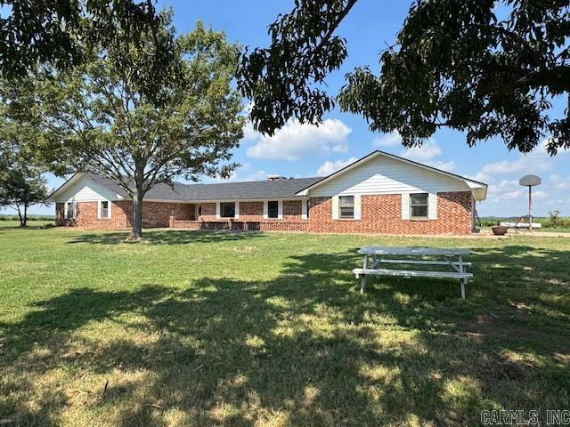 This spacious 3,980 sq. ft. brick home, perfectly situated on a beautiful rural setting just north of Carlisle. Set on 5 acres and accessible via a paved road, this property is ideal for families or hunters seeking a private, expansive lodge. Inside, you'll find 4 oversized bedrooms and 3 bathrooms, providing ample comfort. The cozy den, boasting a vaulted ceiling, wood beams, and a wood-burning fireplace with an insert, invites relaxation. For entertainment, an enormous game room opens to the patio, perfect for gatherings. The spacious kitchen, connected to both a dining room and a breakfast room, offers plenty of room for family meals. Additional features include a large office for work-from-home convenience and a craft/miscellaneous room with ample storage, and a untility room with lots of cabinets. Recent updates such as a roof replaced just two years ago, new HVAC units installed in 2022, and an oversized garage with a new automatic door opener enhance the home's appeal. Located in the Carlisle School District.