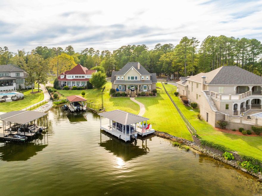 THE BEST OF LAKE LIVING with AMAZING VIEWS! Enjoy all that Lake Hamilton has to offer in this waterfront estate in the highly sought after Water Oak Estates. This immaculate home features 4 bedrooms 3.5 baths with bonus room plus an office with a lake view. Master suite with fireplace on main level, eat in kitchen with granite countertops and stainless appliances. Living room as floor to ceiling stone fireplace with 22 ft ceilings. Other rooms include formal dining room, large laundry room and bonus sleeping area/bunk room and playroom/media room. Includes covered boat dock w/ lift. Expansive lake views to enjoy from covered back porch with sun screen. A LAKEFRONT PARADISE FOR SURE ! Subdivision has boat & RV storage as well as gated boat ramp.