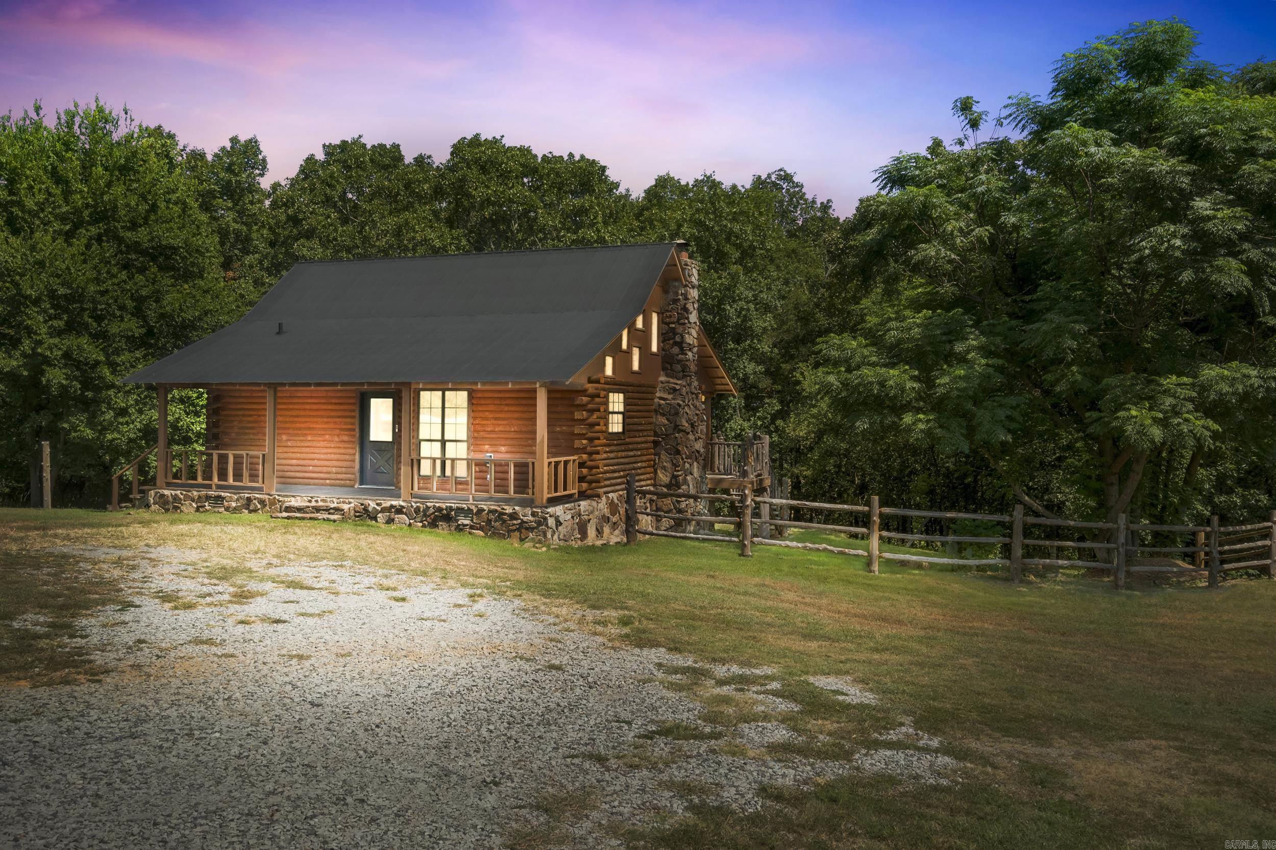 If you are seeking a home with privacy look no further. This home features a one bedroom, 1 bath with a loft area that could be used as a second bedroom, study or recreation room. Kitchen has new countertops and rustic floors throughout. This cabin boasts a floor to ceiling rock fireplace, pine walls and back porch to enjoy the frequent deer and other wildlife. Recent improvements are 2 year old HVAC, complete refinishing of log siding, New roof on the shop 22X18 and has a unique cedar back porch with steps and fencing. The shop is wired 220. This cabin is move in ready and in wonderful condition. New HVAC in 2022, new roof in 2021. Call to see!
