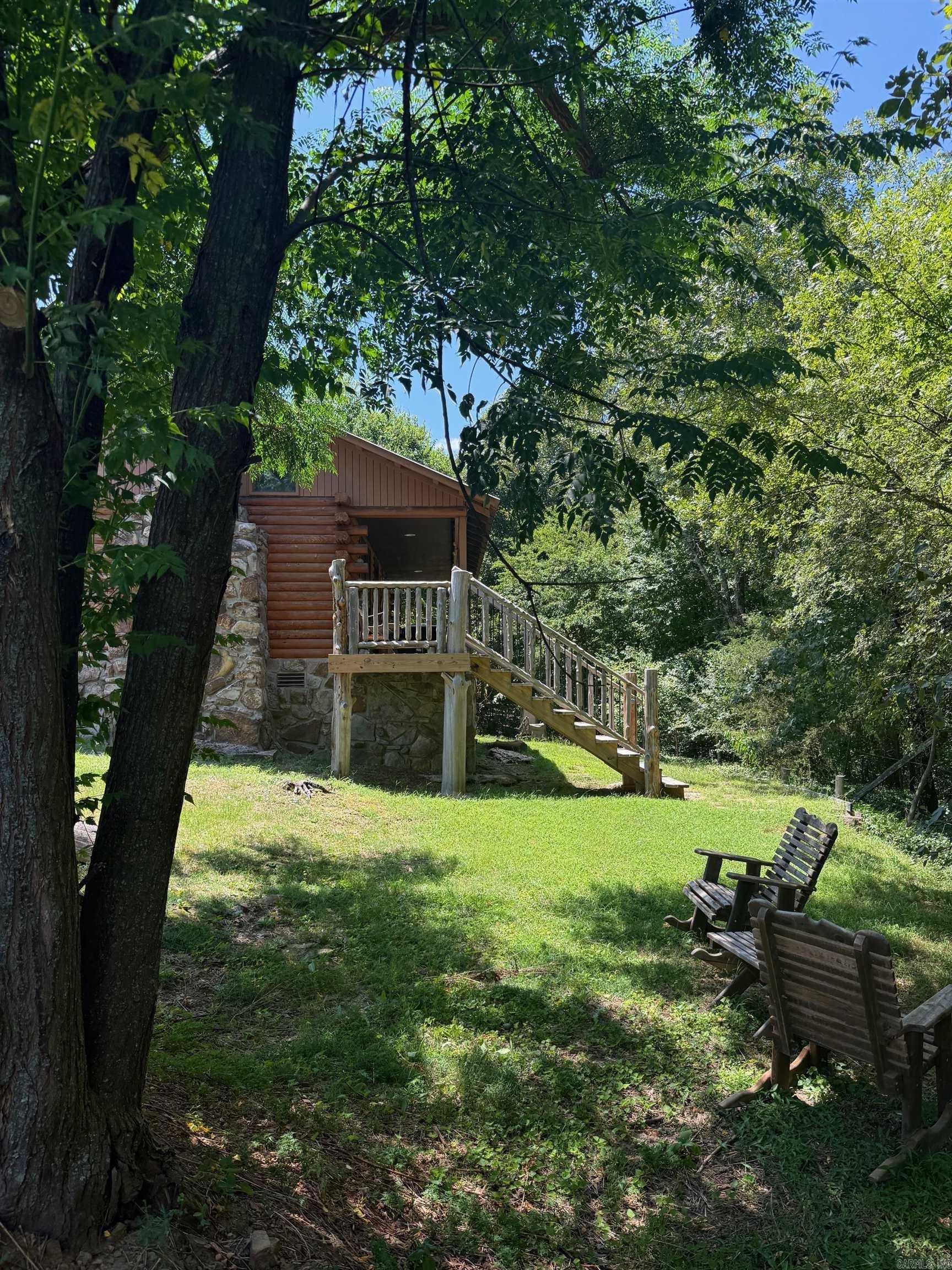 If you are seeking a home with privacy look no further. This home features a one bedroom, 1 bath with a loft area that could be used as a second bedroom, study or recreation room. Kitchen has new countertops and rustic floors throughout. This cabin boasts a floor to ceiling rock fireplace, pine walls and back porch to enjoy the frequent deer and other wildlife. Recent improvements are 2 year old HVAC, complete refinishing of log siding, New roof on the shop 22X18 and has a unique cedar back porch with steps and fencing. The shop is wired 220. This cabin is move in ready and in wonderful condition. New HVAC in 2022, new roof in 2021. Call to see!