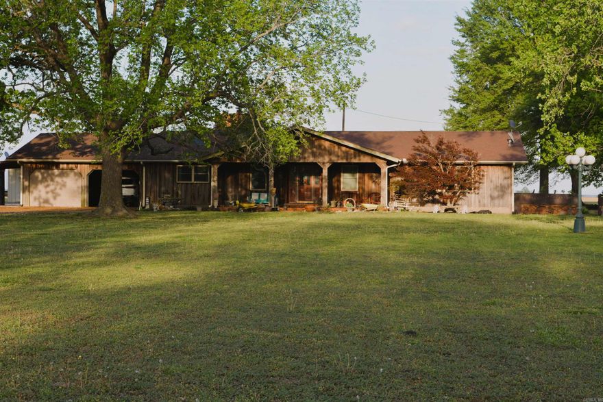 Welcome to country living at its finest! Situated on 5 beautiful acres, this 3-bedroom, 2-bath traditional home with a 2-car garage, laundry room, and large sunroom offers 2,900 square feet of comfortable living with the perfect blend of privacy and convenience. Inside, you'll find an upgraded kitchen featuring beautiful cabinetry, a center island, separate eat-in bar, and pantry, ideal for everyday living and entertaining. Luxury laminate flooring and wood-look tile flow throughout the home. The spacious family room showcases stunning ceiling beams and a cozy wood-burning fireplace. Outdoors, enjoy mature trees including pecan, walnut, pin oak, and pine, creating a serene setting. A 30x80 insulated metal shop with heating and air conditioning is a rare and valuable feature, ideal for hobbyists, business use, or additional storage. Located on a paved road, this property provides the perfect balance of rural privacy and accessibility, just minutes from shopping, city conveniences, and major employment centers. This is more than a home--it's a lifestyle!   Qualifies for Work Here, Live Here program in Mississippi County, Arkansas.