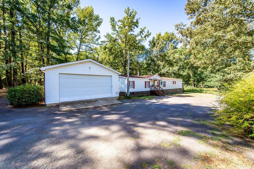 Talk about space! This mobile home is over 2100 sq feet and has been very well taken care of. New flooring and paint throughout. The primary bedroom is HUGE and has a large attached bath with separate walk in shower and tub. There's a large walk in closet as well. Tons of storage space throughout the home. Open floorplan with kitchen, living, and dining. Detached two car garage for parking or use as a shop. All sitting on over an acre. Call today to see this one!