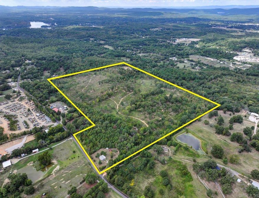 61 ACRES OF PRIME LAND with Existing Home and Development Potential minutes from Downtown! This incredible property with a pond is perfect for your secluded dream home for peaceful country living or homesteading dream.  There's already a gated entrance in place and two convenient access points from Fleetwood & Stardust making it easy for you to enter & exit your property.  The land offers endless possibilities for developers or investors! Featuring 59.9 acres of cleared land just off Albert Pike Hwy.  The beautiful pond near the entrance adds charm & appeal, making it a standout feature.  The home on almost an acre of frontage on Fleetwood Rd has been completely renovated and is move in ready for it's new owner! Custom cabinets, new floors, paint, butcher block countertops. Could possibly rent for $1000-$1500 a mo. Whether you're looking to create a new subdivision or a private retreat, this property is an ideal investment opportunity in our growing community. COME AND SEE!!  **Seller is open to splitting the house with 20 acres and selling the other 40 acres separately.  **Seller financing is available to qualified buyers.  Agents - Call Showing service to schedule all showings.