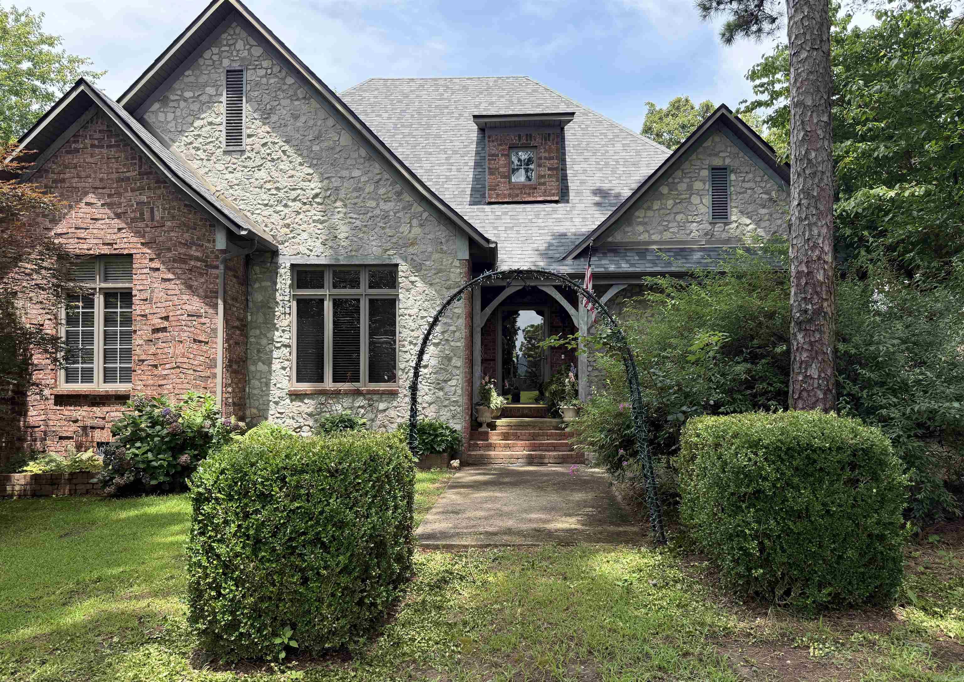 Tucked away in the breathtaking Ozark Mountains, this stunning Country French-style estate offers luxury, charm, and tranquility on 20 picturesque acres—ideally situated with acreage spanning both city and county lines. From the moment you arrive, you’ll be captivated by the elegant architecture and timeless appeal. As you walk through the front door you will notice the teller windows that front the home office. The heart of the home is a chef’s dream kitchen, featuring premium appliances, custom cabinetry, and a spacious layout perfect for entertaining or crafting gourmet meals. The master suite is the stuff dreams are made of, boasting soaring ceilings, a spa-like ensuite bath, massive walk-in closets, and private access to the outdoor patio where you can enjoy the privacy this land offers. Downstairs, the finished basement is an entertainer's paradise, complete with a game room, safe room, and ample space for gatherings. The estate also includes a charming guest house with a versatile craft room and a fully equipped workshop/garage, ideal for hobbies, hosting, or extended stays. This estate offers more than can be listed here so call today and schedule your showing!
