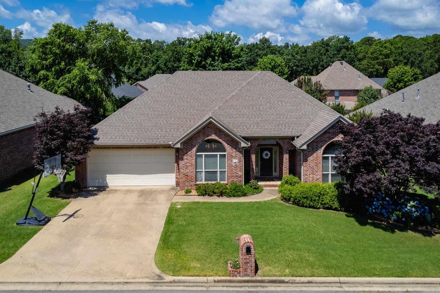 Spacious one level, all brick home with great curb appeal and thoughtful updates. This well-maintained property features tall ceilings, neutral paint, and wood floors in the foyer. The large eat-in kitchen offers abundant cabinet and counter space, informal dining, and a walk-in pantry. A formal dining room also with wood floors provides additional space for gatherings. The light-filled living room includes a gas log fireplace and overlooks the fully fenced backyard with a covered deck, perfect for relaxing or entertaining. The split floor plan offers privacy, with a generous primary suite featuring attractive bath with two closets, a jetted tub, and a large walk-in shower. Two guest bedrooms share a hall bath, while a fourth bedroom with vaulted ceiling makes an ideal office or media room. Additional highlights include a laundry room, two-car garage with storage, new HVAC and water heater (2023), new garage springs and rollers (2025), and roof replaced in 2018. Move in ready! Come see.