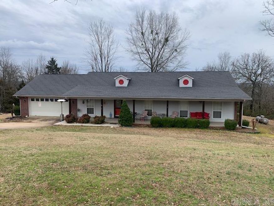 Situated on a large 3 acre lot surrounded on three sides by trees, this property offers peace and tranquility.  The first thing you will notice is porch which runs the length of the home and has been custom coated and is offset by solid western cedar porch posts - the perfect spot to enjoy morning coffee or evening sunsets.  This home has 4 bedrooms and 2 1/2 bathrooms with ample space for comfortable living.  Kitchen/Dining space includes a nice sized kitchen area with plenty of countertop space, large pantry and a breakfast area that has access to the back deck as well as a formal dining space on the opposite side.  The large living room features a vaulted ceiling and fireplace with gas logs.  For buyers looking for a little outdoor space, you'll have plenty to enjoy here.  Large back deck overlooks a private back yard which makes it perfect for entertaining guests or just enjoying quiet time enjoying nature.  Additional upgrades include new water heater and additional attic insulation in 2021; minisplit heat and air in garage in 2019; and new light fixtures and fans with remotes 2018.   Call for your appointment to view this property today!