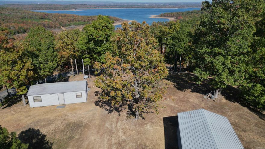 Here it is!!! What everyone is looking for! NO RESTRICTIONS with the breathtaking view of Greers Ferry Lake. All the hard work for the perfect building spot has already been done. Stay on site in the cozy cabin while you build your forever home. Not ready to build right away, then you have the perfect lake getaway ready and waiting. Storage building with concrete floor and electricity for boat and all the lake toys. Circle drive for the ease of pulling trailers in and out and also provides plenty of parking. This property is on a well. Agents, please see all remarks.