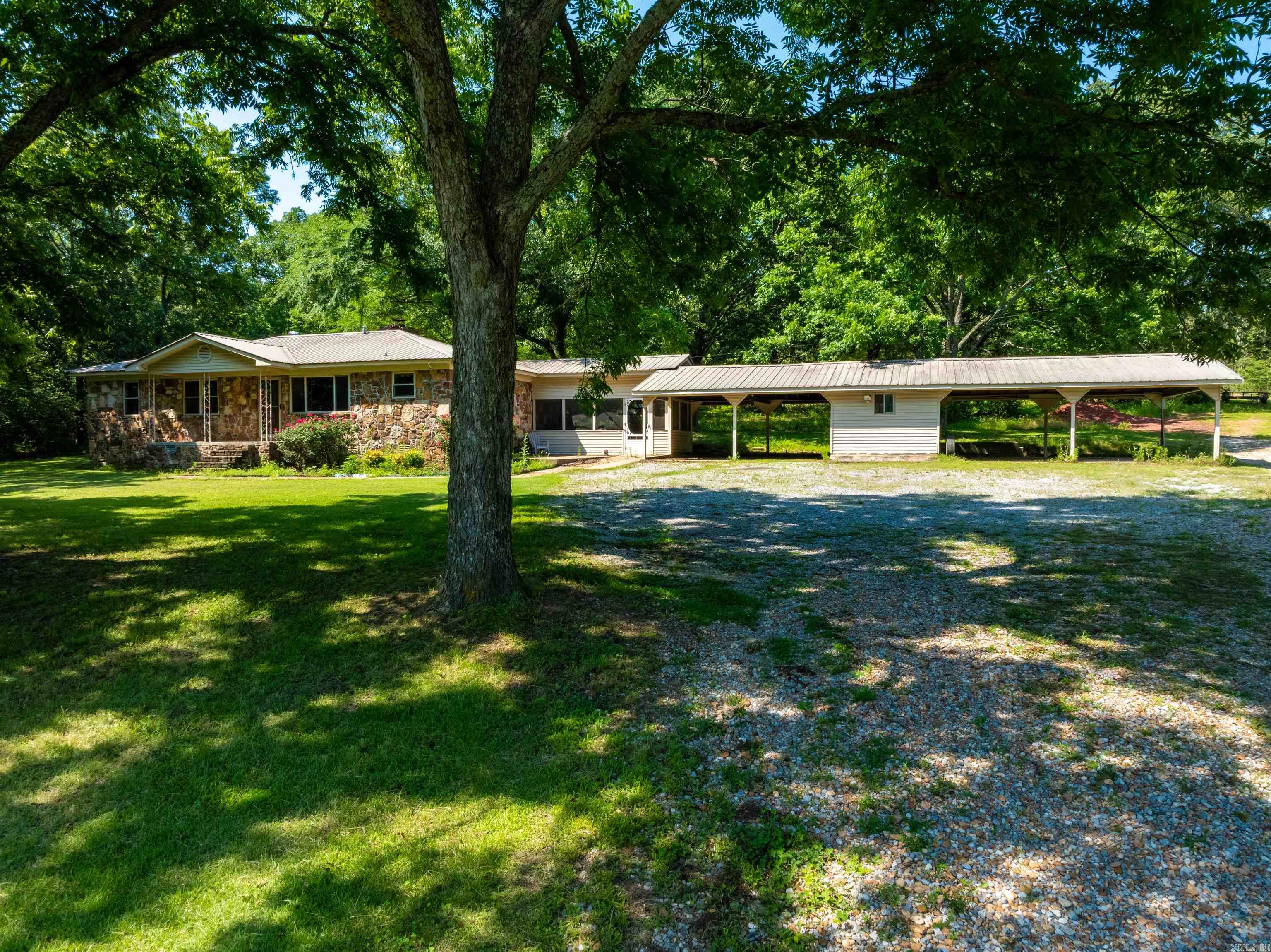 Tucked away on 18± acres just outside of Batesville, this property offers space, privacy, and flexibility. The main home is approx. 1,440 sq ft and features 3 bedrooms, 2 baths, a cozy fireplace, updated hardwood floors, newer HVAC (approx. 3 years old per seller), updated windows, and a metal roof. The kitchen is spacious with stainless appliances, including a vent-hood microwave, electric stove with oven, and dishwasher. A screened-in porch sits off the den, and thereās a 4-car attached carport with a storage room in between bays. A 2005 2-bedroom, 1-bath mobile home sits on one side of the property and is currently rented for $500/month, making this a great income opportunity. Behind the homes is a 20x30 wired shop with electric, a barn, garden areas, and room to hunt or ride ATVs. Thereās also an old 16x32 pool frame still in place that needs a liner and some TLC. The land offers a peaceful setting with mature shade trees and open areas for small livestock or gardening. A 750-gallon propane tank, generator, and ADT security system will remain. This property has the space and setup to live, work, relax, and earnādonāt miss it!