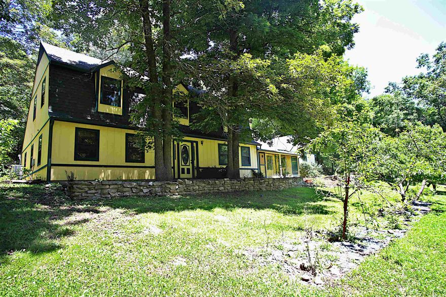 Discover a tranquil retreat on this 5-acre homestead in the heart of the Ozarks! Little Sugar Orchard Creek flows through the property, and includes a roomy, 2-story country home with 2 native stone fireplaces. Perfect for homesteading, the property includes a well, two barns, a greenhouse, and a fully fenced pasture ready for the animals. The property boasts fruit-bearing trees like peaches, pears, cherries, and apples. Additionally, there are fruit bushes such as grapes, figs, currants, mulberries, raspberries, blackberries, and blueberries. The well provides drinking water and supply for animals and plants. The greenhouse collects rainwater in two IBC containers, and an IBC in the barn ensures steady water supply for livestock.