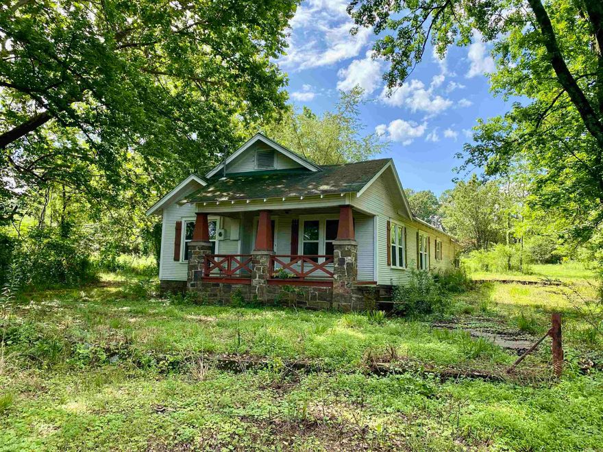 Charming Fixer Upper craftsman-style home with loads of potential, situated on 4.63 acres on the edge of town. This 3-bedroom, 2-bath property offers an open-concept living and dining area, and features an updated kitchen with newer cabinetry and solid surface countertops from a full remodel completed 12 years ago.  Though full of character, the home is in need of repairs including subfloor work, a new roof, HVAC replacement, and general interior updates. The property also includes a large workshop and an old barn—ideal for storage, hobbies, or future restoration.  A rare opportunity to own a home on acreage at an affordable price. Sold as-is and priced accordingly. Bring your vision and make it yours!