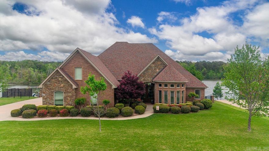 Experience refined lakefront living in the prestigious Hurricane Lake Estates. Perfectly positioned on the water with private dock. This exceptional luxury residence offers an elevated lifestyle defined by comfort, elegance, & breathtaking views. Designed to capture the beauty of the lake from multiple vantage points. The home features a stunning sunroom with panoramic waterfront views, creating the perfect setting for morning coffee or evening relaxation. The spacious primary suite also overlooks the water providing a serene retreat. Primary bath has soaking tub, separate shower, double vanities & a safe room closet. The thoughtfully designed open floor plan balances everyday functionality with upscale entertaining while the windows invite natural light & showcase the scenery. You will love the spacious  three car garage, wrought iron fencing, the deck & wonderful boardwalk!  This is a rare opportunity to own an elegant lakefront property!