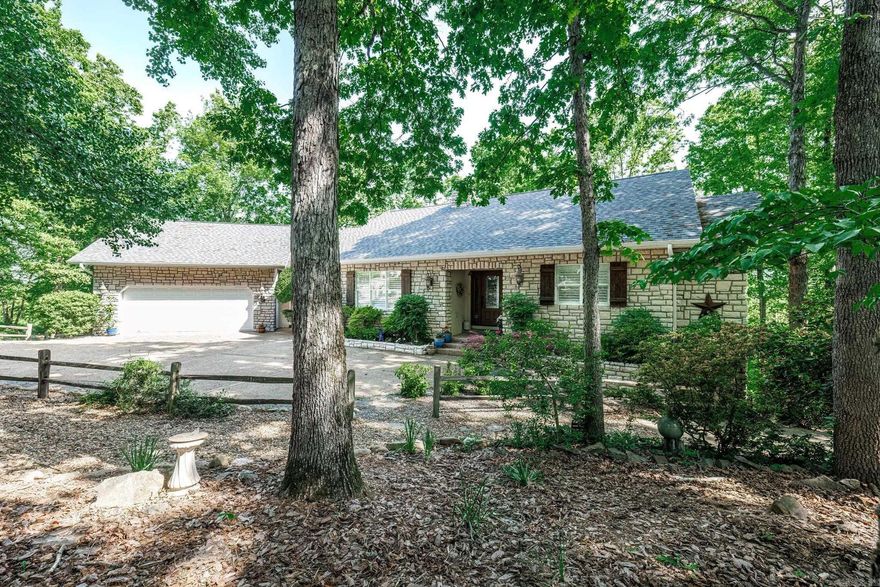 Oh what a view! Have your morning coffee on the deck and watch the sunrise over the mountains.  This custom built home offers 3 'Arkansas' rooms, one off the living room, one off the owners suite and one off lower living room.  Easy driveway into the oversized 2 car garage that can accommodate 2 cars, a golf cart and room for storage or workshop. Beautiful street appeal with lovely landscaping, stone and EFIS front. Kitchen has custom butcher block island.  Everywhere you look is a closet or storage. The lower level could be used as MIL suite with living room, bedroom, bath and craft room. The house sits on .97 acre and the adjoining lot is 1.53 acres.  Properties may be sold as single transaction at $477,000 or separately for $427,000 for lot with house, and $50,000 for adjoining lot.   See agent remarks for additional features.