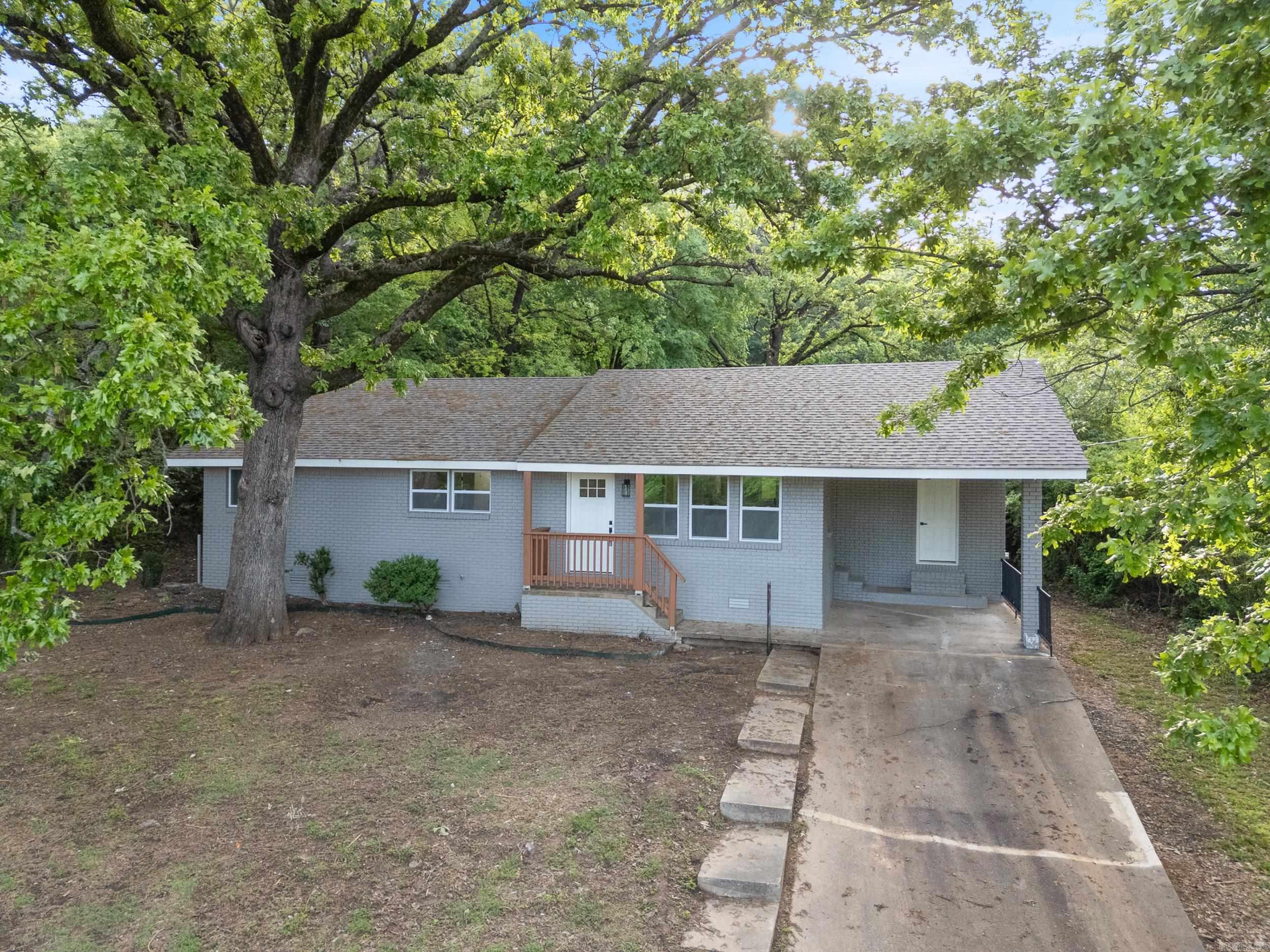 Beautiful country home that has been extensively remodeled with stunning finishes throughout and a new roof with architectural shingles! The home is nestled amongst the shade trees in a great location right in Coal Hill. Shopping at DG is across the street and Johnson County Westside Schools are right up the road. Open floor plan with living room that flows seamlessly into the kitchen. Separate dining room with a light and airy view into the back yard. Granite countertops in the kitchen and bathrooms. All new luxury vinyl flooring, new paint, and new fixtures throughout the home. The back yard is the perfect spot for enjoying a BBQ with friends under the mature shade trees. The new roof will make obtaining homeowner's insurance much easier and will also save you money. Schedule your private showing today!