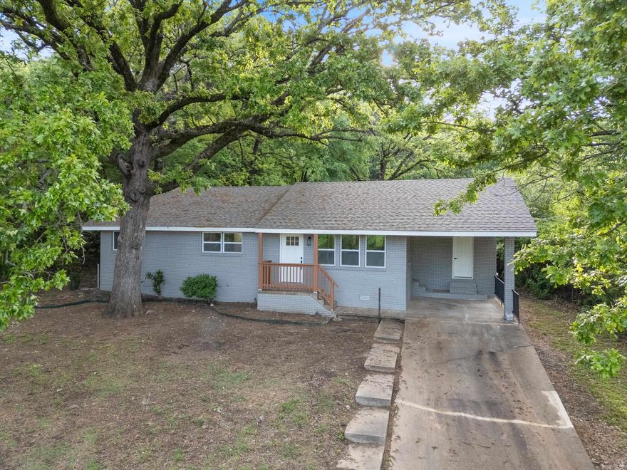 Beautiful country home that has been extensively remodeled with stunning finishes throughout and a new roof with architectural shingles! The home is nestled amongst the shade trees in a great location right in Coal Hill. Shopping at DG is across the street and Johnson County Westside Schools are right up the road. Open floor plan with living room that flows seamlessly into the kitchen. Separate dining room with a light and airy view into the back yard. Granite countertops in the kitchen and bathrooms. All new luxury vinyl flooring, new paint, and new fixtures throughout the home.  The back yard is the perfect spot for enjoying a BBQ with friends under the mature shade trees.  The new roof will make obtaining homeowner's insurance much easier and will also save you money. Schedule your private showing today!