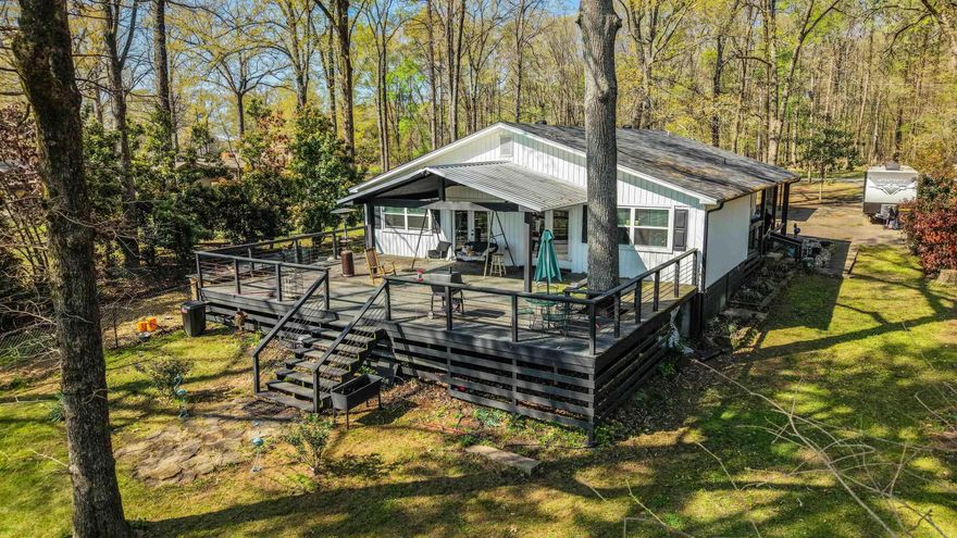 Lake life is calling, and this one answers in style. This updated custom lake home, updated in 2022. It's the kind of place you walk into & immediately exhale. You’ll love the sleek stainless appliances, 5 burner gas stove, a tankless water heater, and newer HVAC with updated ductwork for comfort. The beautiful black swirl granite countertops with island bar add just the right amount of bold character. Every room offers two closets for ample storage.  The primary suite is a showstopper with vaulted wood ceilings, a spacious 20' by 20' layout, and direct access to an incredible nearly 1,000 square foot deck. Morning coffee, sunset dinners, or hosting friends. This is where memories get made, all with a front row seat to the lake and all of the beautiful nature.  And here’s the exciting part, Lake Conway is on track to return in 2028 after a full dam rebuild, silt removal, & major habitat improvements. That means you are not just buying a home, you're getting in ahead of the comeback. Last 5 photo are from before lake renovation.