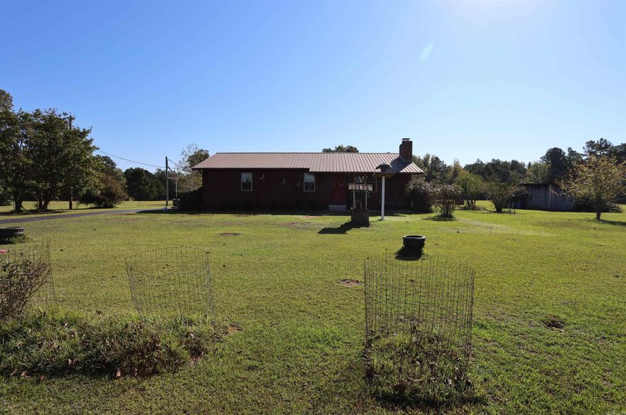 If you're looking for privacy and country living you will find it here. This 3 bed 2 Bath home comes with a covered Patio, a 14x30 lean-to for your farm implements, and a large concrete floored shop and storage building. The 20 KW Generac Generator and the asphalt drive way are nice additions to  this property.   The 50 acres is well stocked with a mixed stand of hardwood and pine trees, providing great wildlife habitat.  If fishing is your thing, the almost 2 acre pond is the place to be.