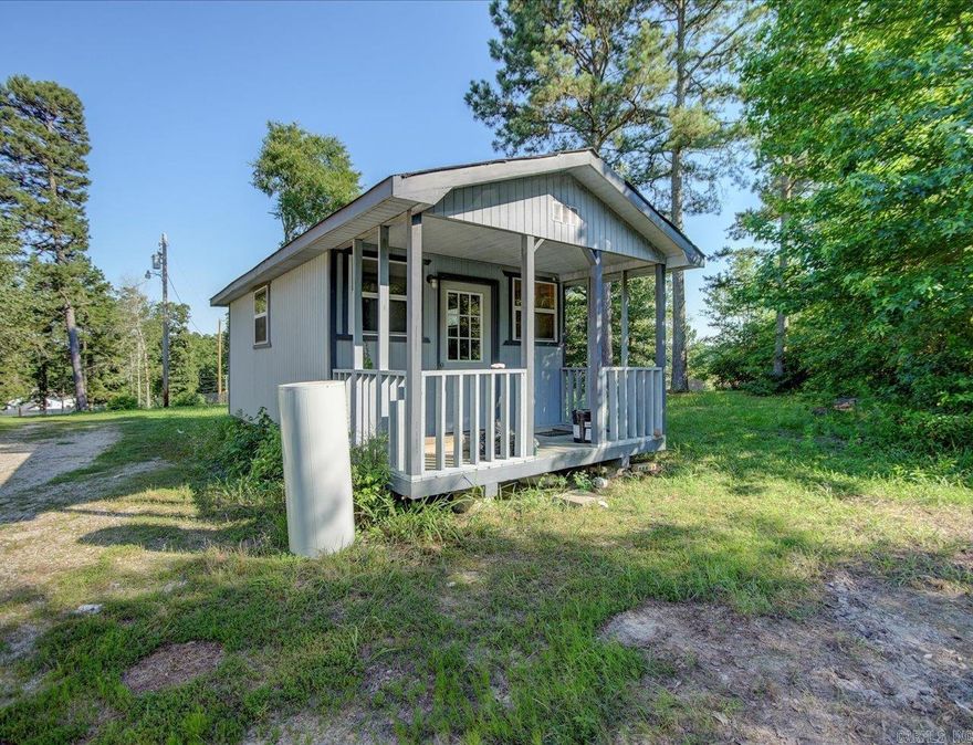 NEW ROOF to be installed prior to closing.  Charming manufactured home and tiny home/shop is situated on a spacious 1-acre lot in a fantastic location! This property features 3 bedrooms and 2 baths, offering plenty of space for your family. While it could use a little TLC with fresh paint and new flooring, it has great potential to become your dream home. The property is sold as is.  In addition to the main home, you'll find a nice shop that could double as a tiny home, a shed for extra storage, and a storm shelter for peace of mind. The cement driveway leads to a convenient carport, ensuring plenty of parking space. Plus, the property is equipped with a whole house generator, ensuring you're never left in the dark.  The neighborhood is friendly and welcoming, making this a perfect spot to settle down.