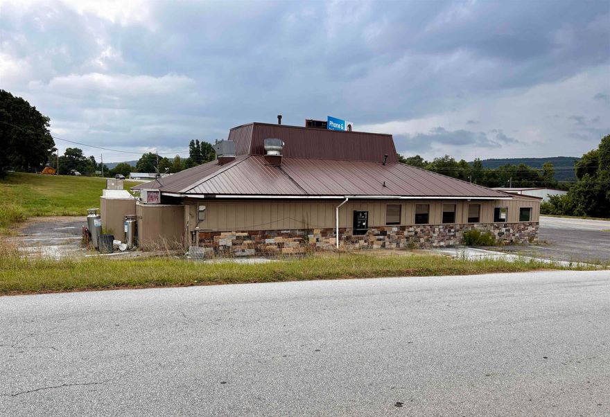 Prime location in Marshall, AR! Great visibility and high traffic area!  So many possibilities with this property. It has been leased in the past for a restaurant. Large parking lot! 2 years ago seller added fresh paint inside and out, exterior stone and metal roof. 2 entry doors, drive thru window, large kitchen area with walk-in cooler, big dining area and 2 bathrooms. Selling AS-IS. Contents do not convey.