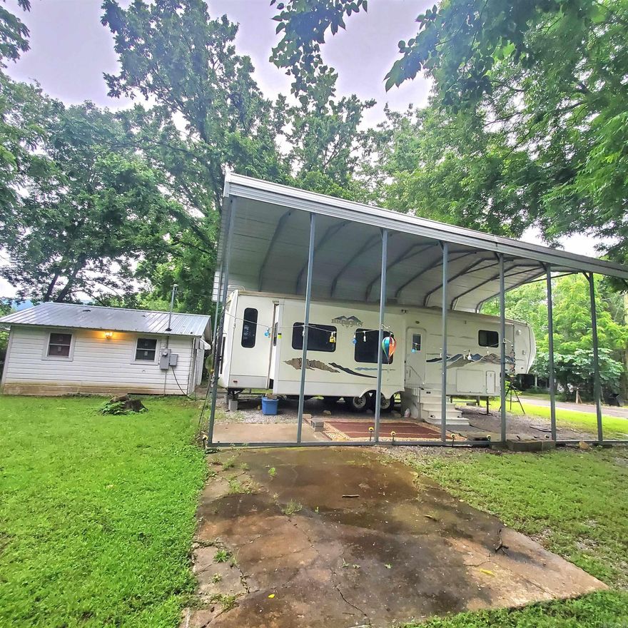 Very well maintained 5th wheel camper with new awning on .33 acre lot in town. Camper is 38 ft with 4 slides. Camper has always been kept underneath an awning or in a storage building. Has a 360 sq ft storage building with a new roof,  with power so you will have plenty of storage space. Most of the furnishings will remain. This is within walking distance of all that the town square has to offer. Makes a wonderful vacation home!