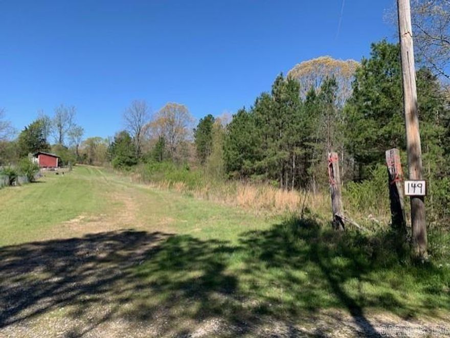 149 Christmas Tree Lane backs up to 100 acre McAlpine Christmas Tree Farm. One and a half miles from Bismarck High School and Middle School. Lots of mature hardwood and pine trees.  Utilities include power and fiberoptic internet at the edge of the property, and access to Kimsey water.  Has already passed perk test for septic.