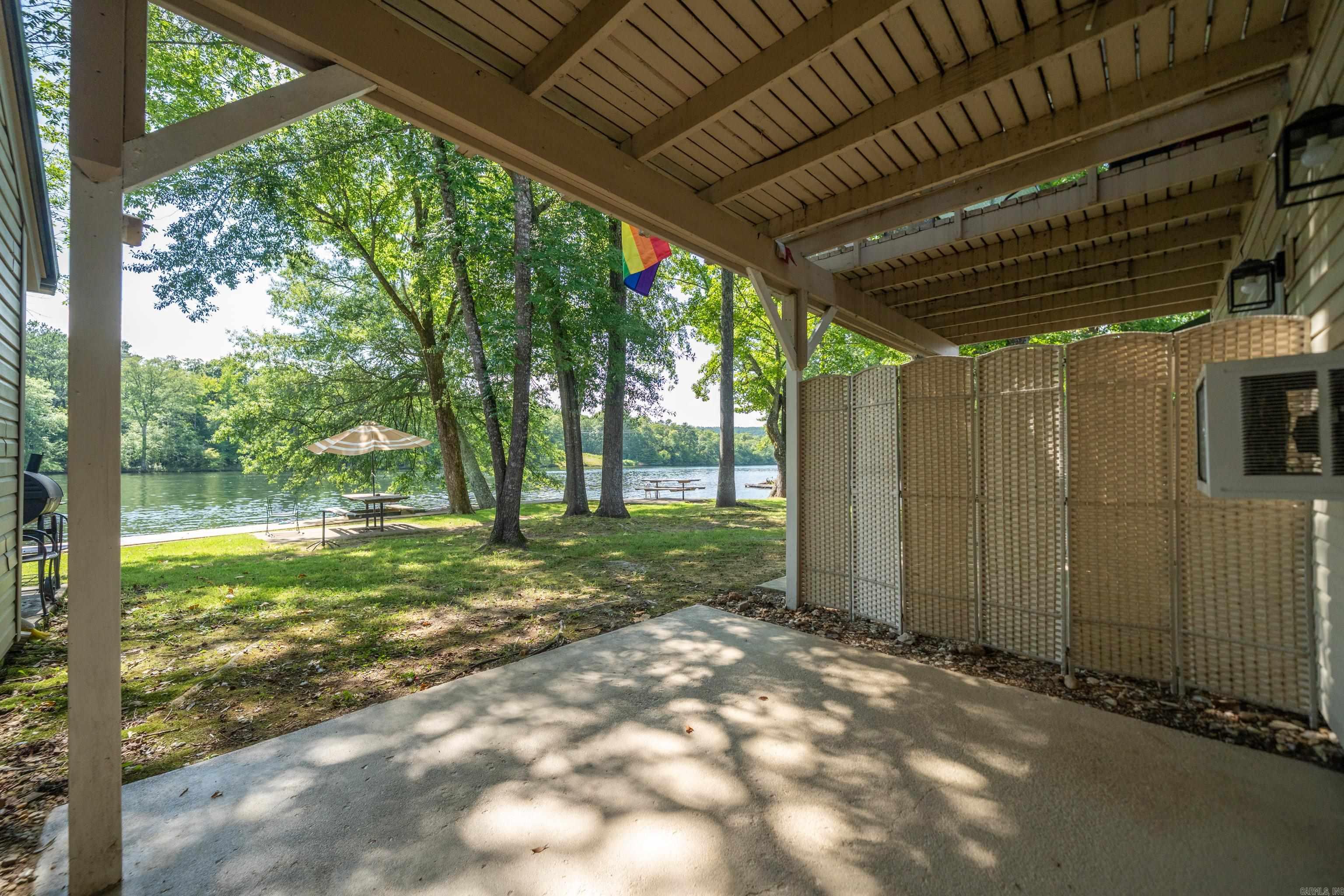 Rare opportunity to own Lakefront Property 30 feet from waters edge at a low, low price that is affordable!. Highly sought after Ground floor. Very beautiful and peaceful place on Lake Hamilton. Cozy 1 Bed 1 Bath Condo has been completely remodeled. New Paint, New Fixtures, and New Luxury Vinyl Flooring. Refrigerator remains. Fantastic Lake Views from inside or Back Porch. New beautiful Boardwalk surrounds the entire lake front property. Great for Fishing or for Boating. Gated Property. No stairs or even steps anywhere to trip over. Tankless Water Heater. Water paid by POA. No used furniture to throw away, ready for fresh new furnishings to your taste. AirBnB's and Short Term and Long term Rentals are allowed with No required Permit.