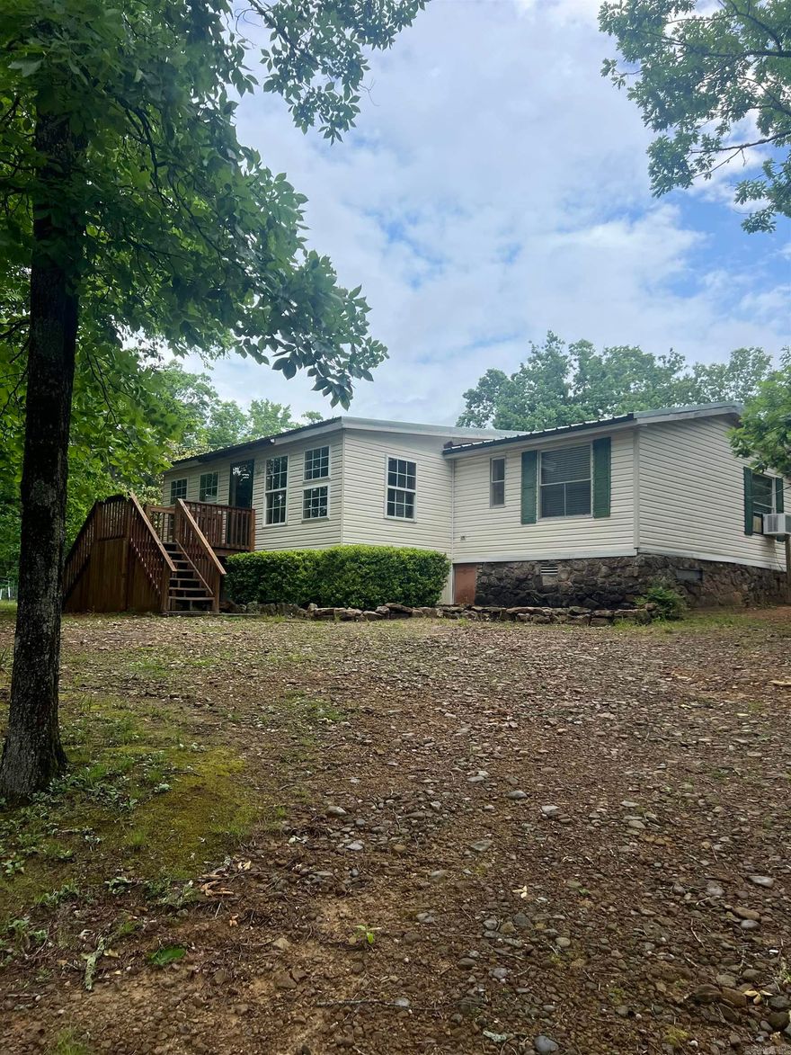 Great home in the country with extra buildings for storage or small farm animals.  3 bedroom 2 bath home with a roomy kitchen, lots of pantry space, new main bathroom and pretty barn doors leading to den. This home has a storm cellar and fruit trees, a big magnolia tree and lots of shade trees.  There is a sunroom on the front and nice screened in porch in the back for enjoying your coffee, the wildlife and the sounds of nature.