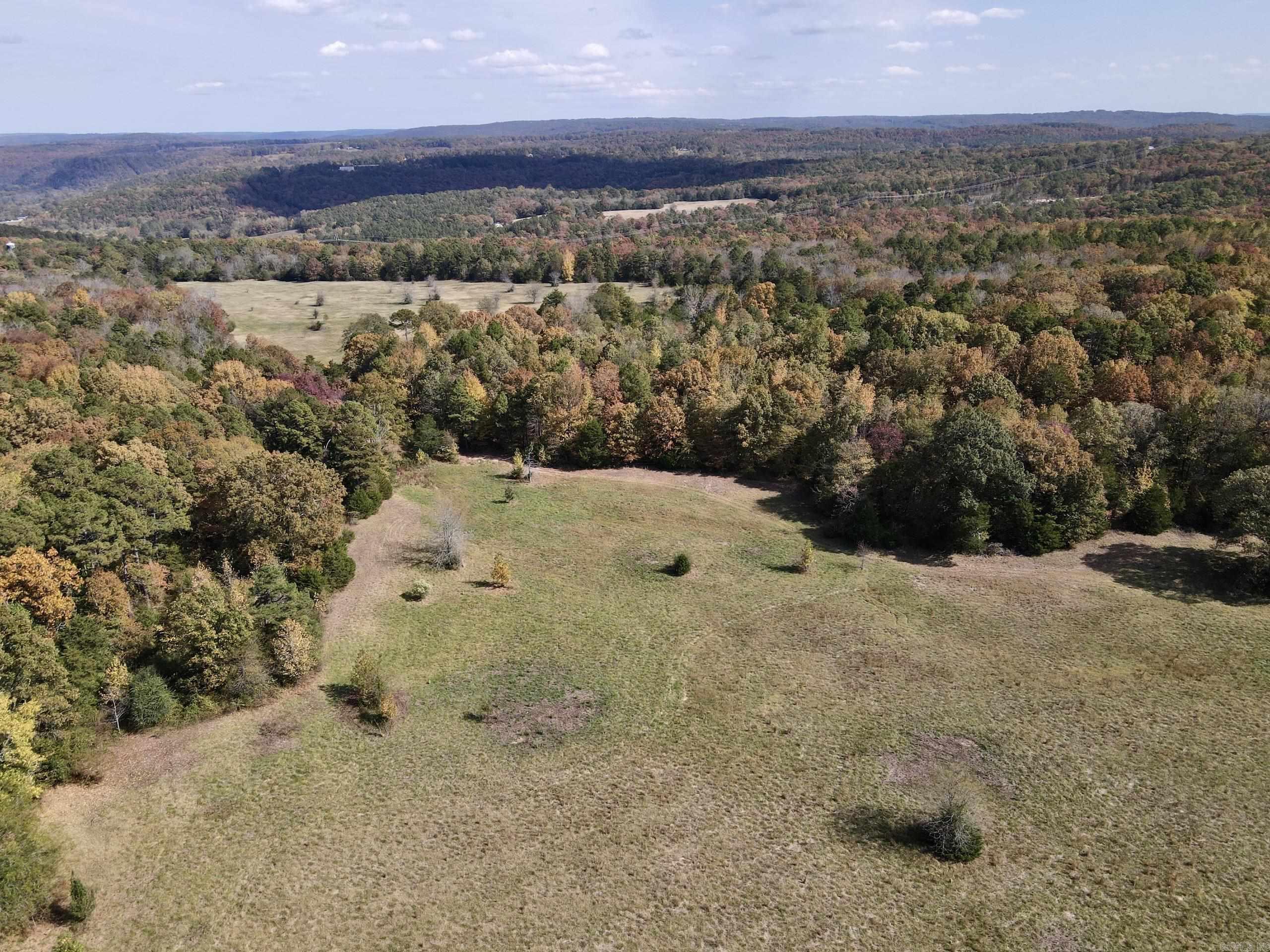 This picturesque farm, located on a paved county road, offers the perfect blend of functionality and natural beauty. A newly constructed gated entrance welcomes you into a pristine open pasture, ideal for grazing livestock or selecting one of several potential building sites that showcase stunning views of the Boston Mountains. Beyond the pasture lies a mature pine and hardwood forest, accessible through a recently improved and widened trail system, perfect for ATV exploration. The property features a seasonal creek that meanders across the land, enhancing its appeal as a serene retreat. Wildlife enthusiasts will appreciate the abundant habitat that attracts deer, bear, and turkey, making it a haven for hunters and nature lovers alike. Located just a short drive from Greers Ferry Lake and the Little Red River, youāll enjoy access to excellent boating, fishing, and world-class trout fishing opportunities. Utilities, including electricity, rural water, and internet, are available, making it easy to build your dream home or getaway. Please note: Mineral rights are not conveyed, but additional property is available.