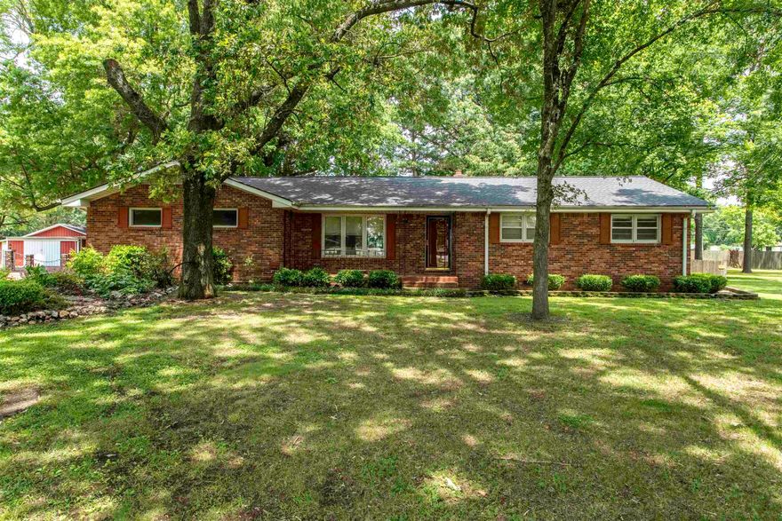 Home in town but with country setting! Charming ranch-style brick home in Bono, AR on 2.17 beautifully landscaped acres! This 1,794 sq ft home offers 3 beds, 2.5 baths, 2 spacious living areas, and a 2-car garage. The layout is perfect for everyday comfort and entertaining, with an abundance of outdoor space surrounded by mature pecan trees, an apple tree, and stunning perennial flower gardens for low-maintenance beauty year after year. Enjoy peaceful country living just minutes from Jonesboro. A 30x50 fully insulated shop with HVAC and plumbing for a half bath is ideal for hobbies or business needs. An additional large outbuilding provides even more storage. Don’t miss this rare opportunity for space, style, and serenity in a prime location! The property has been meticulously maintained and awaits a new owner to walk in and make it there own. The large air conditioned shop which is mostly finished inside would be accommodating to transition as a mother in law quarters. Previous use was for photography. Building has tall side walls and could easily have a car lift installed in it. The land also offers an additional inlet from Hwy 63B that could be used as additional driveway.
