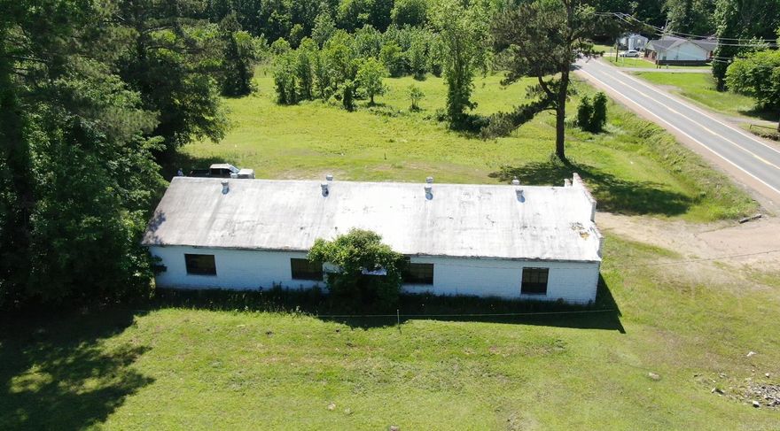 This 12.68 acres of commercially zoned property comes with a 2496 square foot building and an additional 5.67 acres of residentially zoned property.