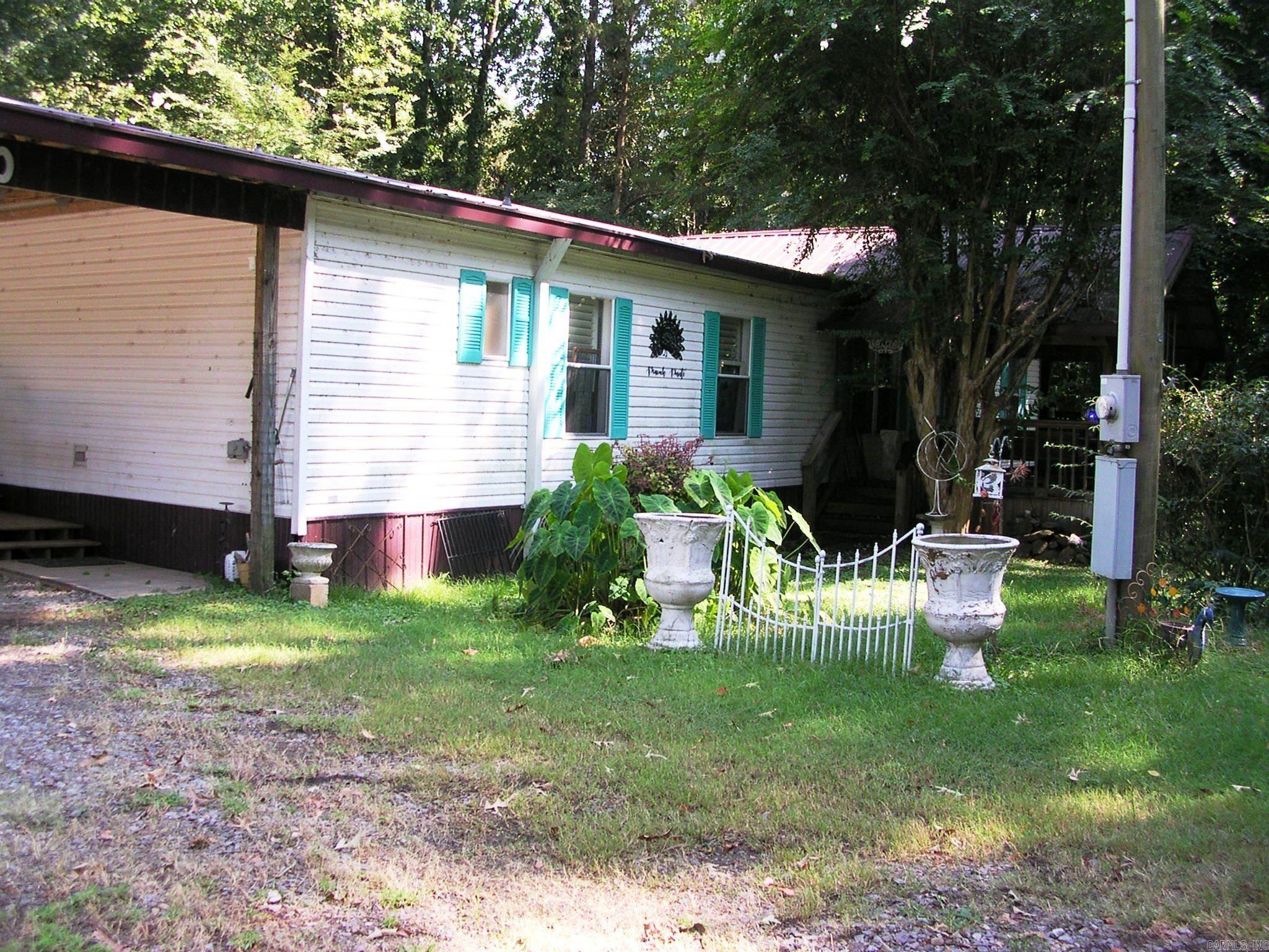 CHARMING SOUTHERN STYLE MOBILE HOME IN PERRYVILLE, AR.!!! WITH IN WALKING DISTANCE TO HARRIS BRAKE LAKE !!! This 3 bedroom 2 bath mobile home has a lot to offer with a large living room and full size kitchen area as well as a large master bedroom. Has newer wide plank flooring in the living/dining room and the master bedroom. Very spacious front and back covered decks with plenty of shade which makes for such a calming space and entertaining area for family and friends. New HVAC installed in 2021 and new Metal Roof put on in 2018. Has a 12x12 storage shed for extra storage. This property is with in walking distance to Harris Brake Lake for some awesome fishing!!! Come check it out!!! "SHOWN BY APPOINTMENT ONLY" "24 HOURS NOTICE TO SHOW"