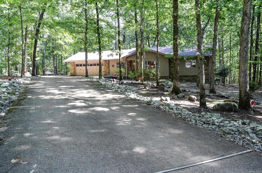 Enjoy the serenity and beauty of the forest from the deck of this well-maintained and updated home situated on a wooded cul-de-sac in beautiful Hot Springs Village, Arkansas. Just minutes in your golf cart to the Cortez Golf Course! The home features granite countertops in the kitchen and baths, LVP flooring, tile, and carpet. A pantry, laundry room, wood-burning fireplace and vaulted ceiling are among the features. There is also a heated and cooled workshop.  New roof 2024. Hot Springs Village has a one-time buy-in fee of $2000 paid at closing. Don't miss this gem in the forest!