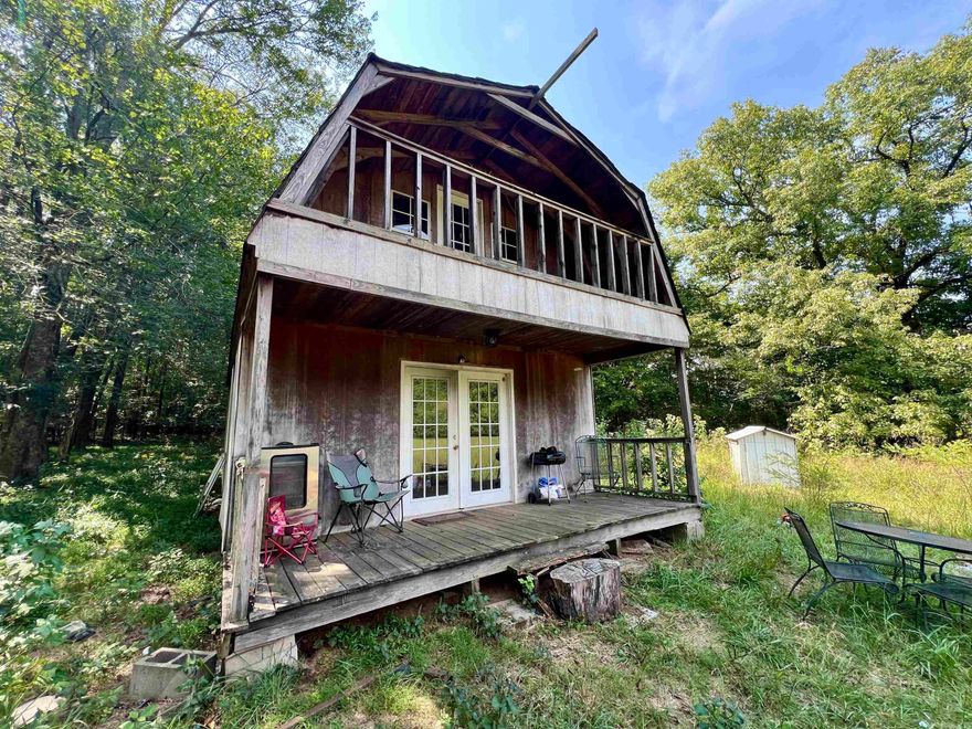Rustic Cabin Retreat Near Wolf Pen Gap Trails & Talimena Scenic Byway Discover your own private getaway in the heart of the Ouachita Mountains. This gambrel-style cabin, complete with a covered front porch and walk-out balcony for soaking in the views. Set on 7.76 level acres of open and wooded land, the property sits along the Sugar Creek branch of the Cossatot River and is surrounded by the Ouachita National Forest, home to deer, turkey, black bear, fox, and other native wildlife. The location is ideal for outdoor adventure: Wolf Pen Gap Trail System and Ouachita National Forest – 400+ miles of ATV/Off-Highway trails;  Talimena Scenic Byway (Skyline Drive) – renowned for breathtaking mountain vistas;  Endless opportunities for hiking, hunting, and exploring nature Whether you’re looking for a weekend retreat, full-time residence, or income-producing vacation rental, this property combines rustic charm, acreage, and proximity to some of Arkansas’s most popular outdoor destinations.