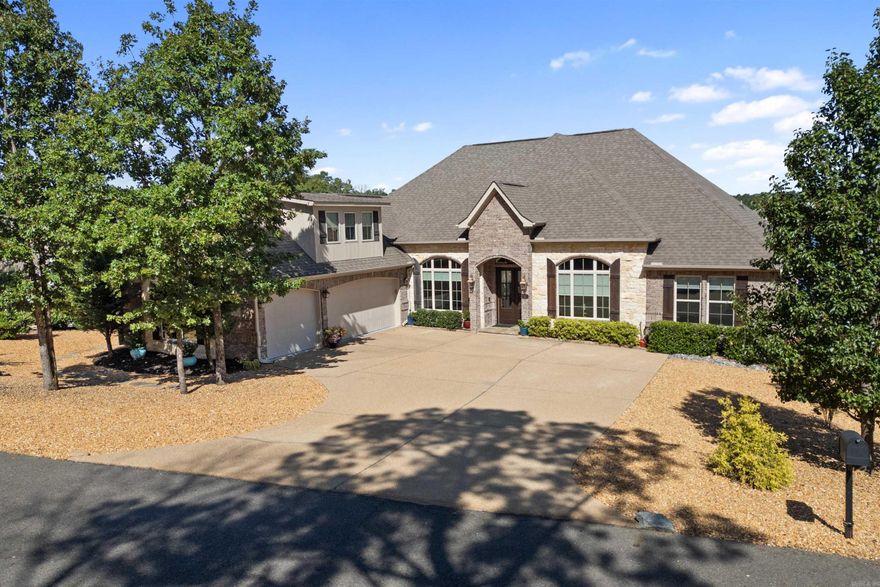 This gorgeous all-brick home with stone accents offers 3 spacious bedrooms and 2.5 bathrooms, blending comfort and elegance. Inside, you'll find a bright, open floor plan with a separate office, a formal dining room, and a gourmet kitchen perfect for entertaining. The home also features a large laundry room with a sink, volume ceilings that create a light, airy feel, and a versatile bonus room upstairs ideal for a media/game room or hobby space. The spacious 3-car side-load garage is complete with sealed concrete flooring for added durability.  Step outside to the inviting covered patio, complete with tile flooring, where you can unwind and take in the peaceful lake views. With a private boat dock and tanning dock, enjoying the water is just a few steps away. The property also includes a well-maintained seawall, stunning landscaping with outdoor lighting, and a drip irrigation system to keep everything lush year-round. For more details, see the Agent Remarks.  Come experience this exceptional lakeside home for yourself—truly the perfect place to relax and make lasting memories!  SEE AGENT REMARKS