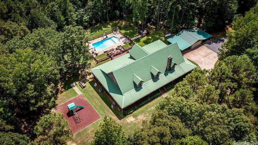 WOW, a true Lakehouse Feel! Privacy with over 9 acres of land that touches Corp of Engineer property (path goes behind a number of houses to get to the lake),Long driveway that leads to the house, Circle Drive w/detached garage,wrap-around porch, swimming pool, hot tub, playground,lots of square footage for hosting guests (Loft on 3rd floor),Completely remodeled kitchen & wet bar around 2015, & Sellers are willing to negotiate selling home furnished.All kitchen appliances, washer, & dryer stay.