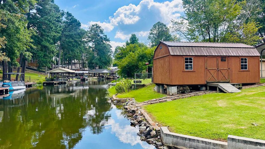 Affordable, Well-Maintained Lake Home with Boat Slip! Tucked away in a serene cove, this 2018-built 3-bedroom, 2-bath home is move-in ready—just bring your boat and fishing poles! With an open floor plan and ample parking, it's perfect for weekend getaways or entertaining friends and family. Enjoy peace of mind knowing your boat is protected year-round with a detached carport, and keep your gear organized in the spacious 12x24 storage shed. Whether you're looking for a full-time residence or a vacation retreat, this property offers the ideal lake lifestyle. All offers will receive a counter at minimum. Move in just in time for the heart of summer and discover why so many are choosing to call Hot Springs home.