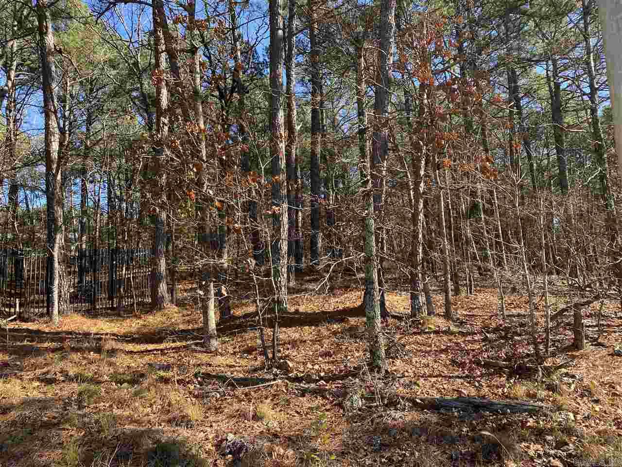 18.25 Acres with private, auto open gate at entrance from Hwy 7, keypad, wood covered land in growing area, modular home with permanent foundation and new roof 2017 plus 3 storage buildings convey "as is". Outside city limits, well & septic, city water at property, 2 propane tanks, beautiful & Peaceful location just minutes from all HSV. Property runs from HWY 7 to Gossage Road.