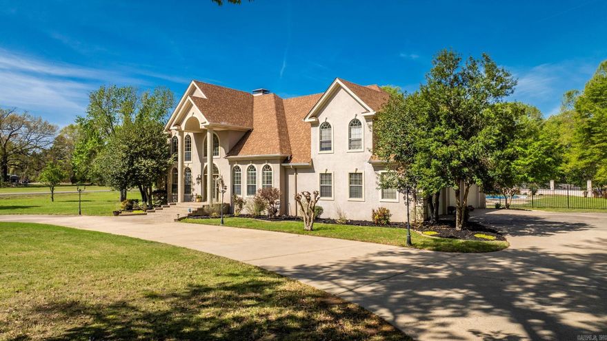 Welcome to 6 Shady Grove—where timeless elegance meets everyday living in one truly unforgettable home. Stately columns create a grand first impression, leading into a light-filled interior with views of the pool. An enchanting floating staircase anchors the home, guiding you to an expansive upstairs retreat with 2–3 bedrooms or a flexible game/media space. The spacious kitchen features granite countertops, an island, and stainless appliances—perfect for gathering. The primary suite is on the main level with a connected office or private sitting area. Three-car garage offers ample storage. A standout feature is the 2,103 sq ft in-law quarters/pool house with bedroom, bath, kitchen, living space, garage, and large craft/work area—ideal for guests, multi-gen living, or working from home. Enjoy your private outdoor retreat with a pool and peaceful pond. One-of-a-kind property offering space, flexibility, and lifestyle. Pool House is sold AS-IS. Updates NEW Paint in Living/Kitchen, Backsplash and Countertop in Kitchen in Pool House. Hot Tub will convey. See remarks.