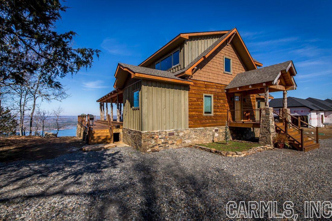 This beautiful custom built home has too many fine features to list. Please visit www.junipertreelodge.com to read all about the home and to see the gallery of photos. Located on Diamond Bluff overlooking Greers Ferry Lake and the Ozark Mountain foothills, the views are amazing. There is a boat launch minutes away at the base of Diamond Bluff; three marinas just a few miles away.  The neighborhood is mostly full time residents, many retired professionals, with a number of weekend homes.