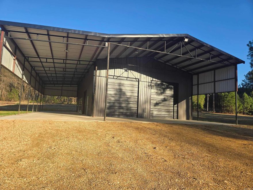 Discover an exceptional opportunity to own 102± acres in Columbia County offering a strong blend of rural living, recreation, and long-term investment potential. The property features a 60x80 unfinished barndominium ideal for a full-time residence, weekend retreat, or hunting lodge.  Inside, approximately 40x60 of enclosed living space is already equipped with plumbing, electricity, and energy-efficient windows. Three large roll-up doors provide convenient access for equipment or vehicles. A 20x60 front pull-under offers covered parking or workspace, while the 20x80 side overhang creates a shaded porch ideal for relaxing, entertaining, or RV parking.  A fully finished portable camp provides comfortable temporary living while completing the main structure and can later serve as a guest cabin.  The land includes a mix of mature hardwoods and managed pine plantation with excellent wildlife habitat supporting deer, turkey, hogs, and small game. Several box blinds and feeders are already in place.  With blacktop road frontage and utilities available, this property offers convenient access and strong potential for development, recreation, or a private rural retreat.